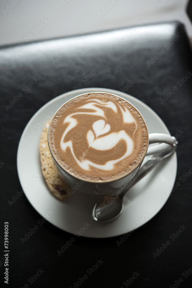 Hot coffee with latte art on black table Hot coffee with latte art on black table