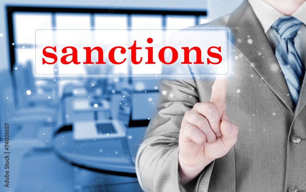 businessman pressing sanctions button on virtual screens businessman pressing sanctions button on virtual screens