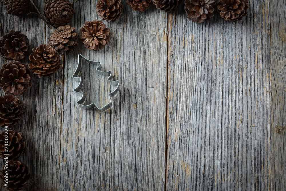 Pine Cones and Christmas Tree on a Rustic Wood Background Pine Cones and Christmas Tree on a Rustic Wood Background