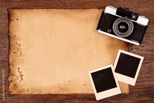Old paper and vintage photo frame with camera.