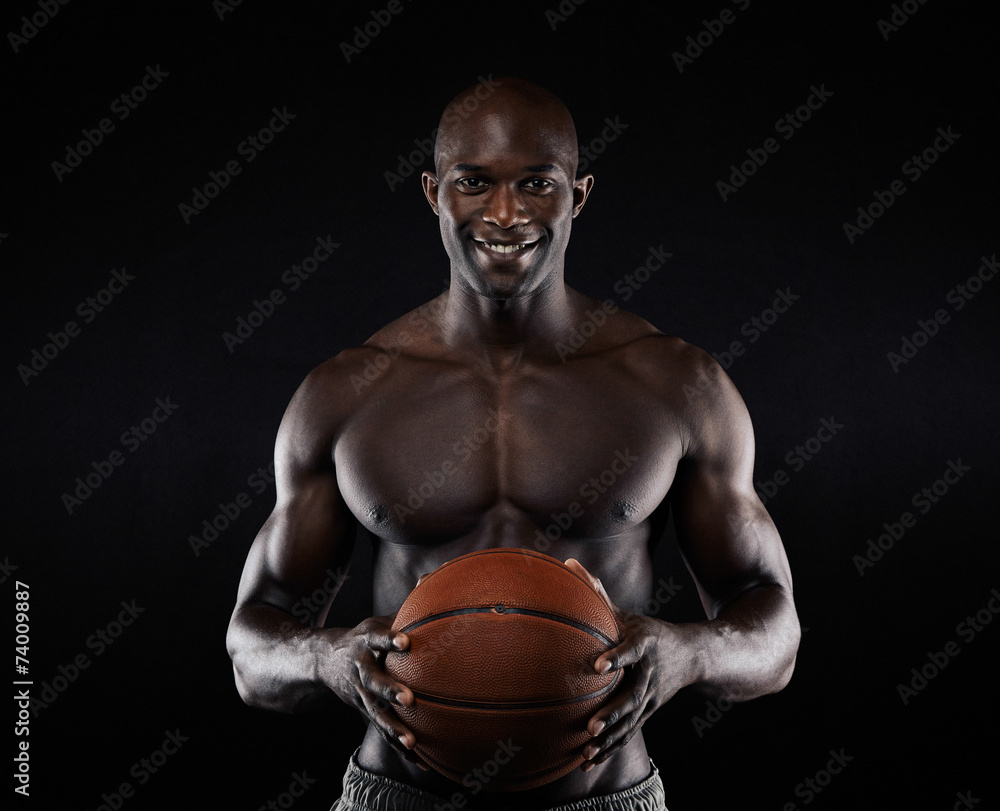 Shirtless basketball player looking at camera smiling. Shirtless basketball player looking at camera smiling.