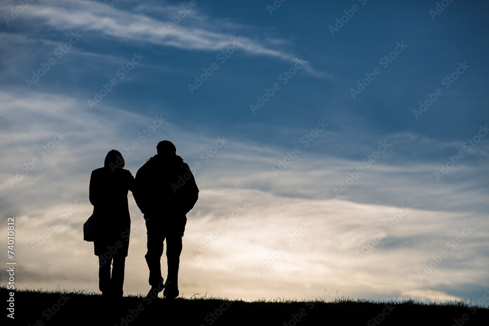 silhouette of elderly couple in sky