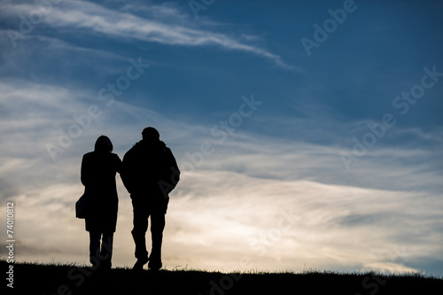 silhouette of elderly couple in sky © Alex Koch