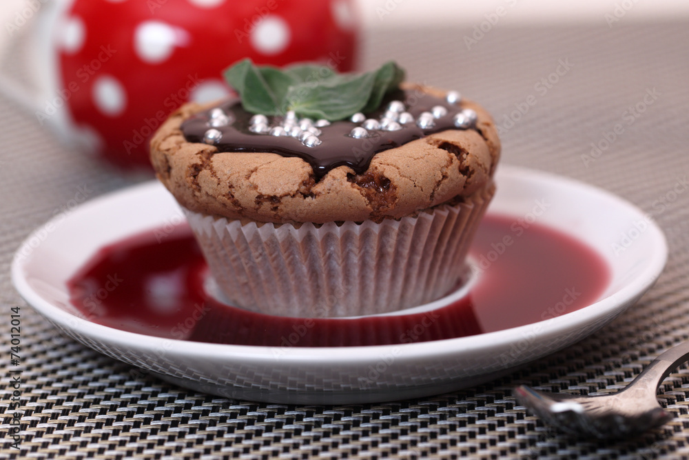 Chocolate cupcake muffin with a strawberry syrup or wine Chocolate cupcake muffin with a strawberry syrup or wine