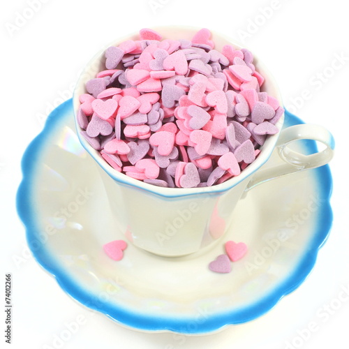 Candy hearts in coffee cup isolated over white