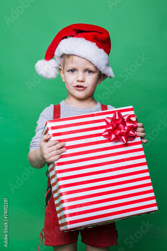 Christmas Elf holding big red gift box. Santa Claus helper