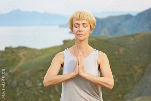 Senior woman doing yoga exercises