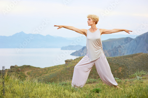 Senior woman doing yoga exercises