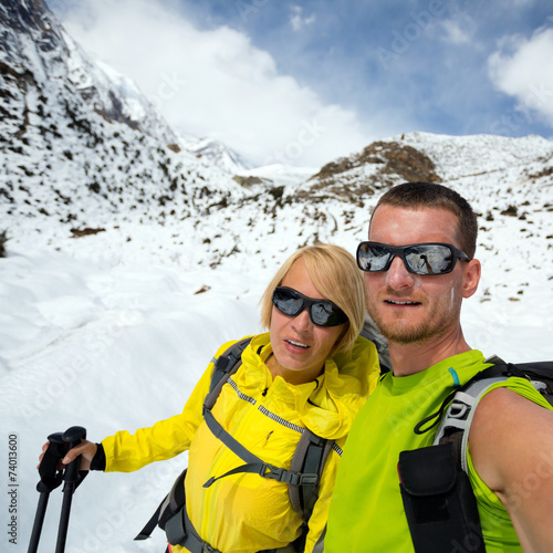 Couple hikers selfie portrait expedition in winter mountains