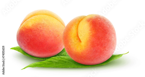 Isolated peaches. Two fresh peach fruits on leaves over white background, with clipping path