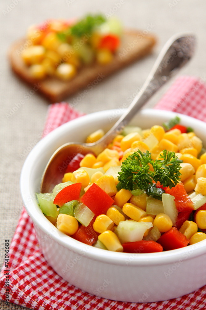 Homemade corn salsa in white bowl with spoon Homemade corn salsa in white bowl with spoon