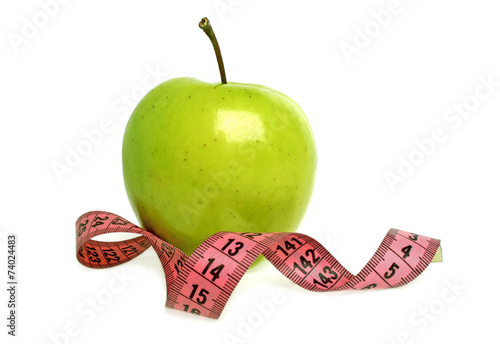 Diet concept - green apple and measuring tape