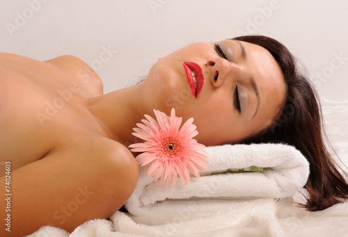 Relax girl with pink daisy flowers isolated black background