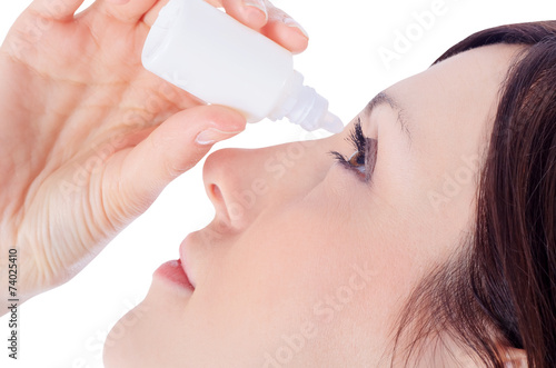 woman dripping eye with eyes drops
