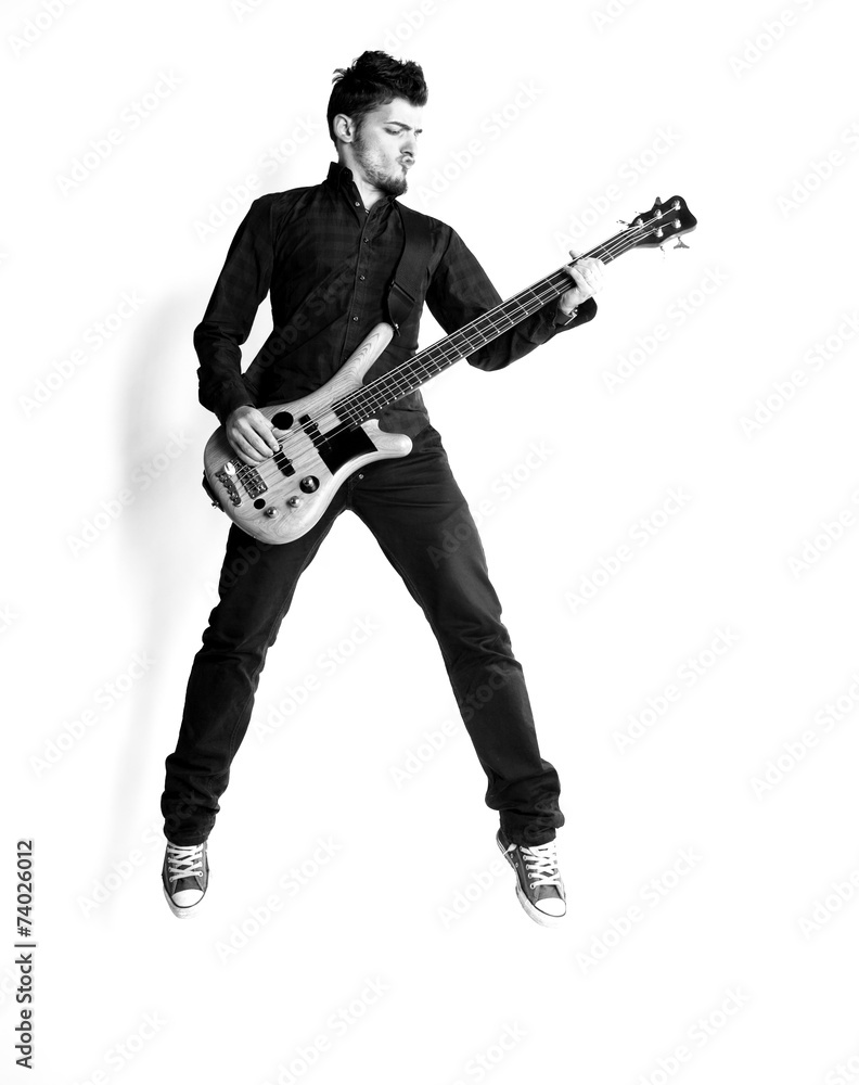 Jumping bass player on a white background Jumping bass player on a white background