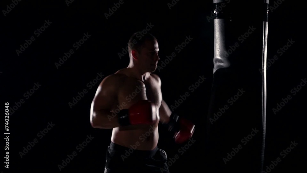 boxer man during boxing hiting heavy bag at training fitness gym boxer man during boxing hiting heavy bag at training fitness gym