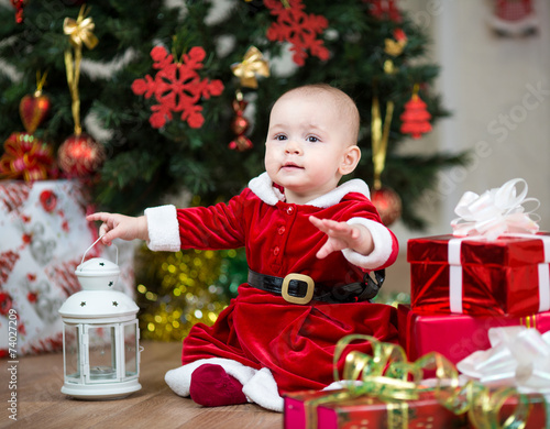 kid with Christmas gift boxes