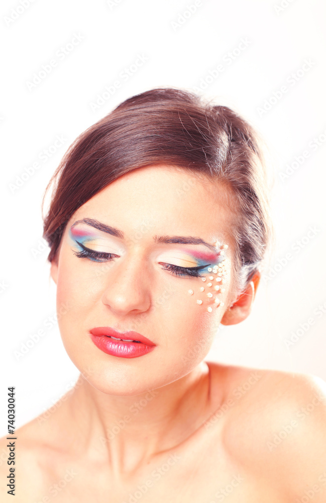 Beautiful woman posing in the studio wearing colorful make up Beautiful woman posing in the studio wearing colorful make up