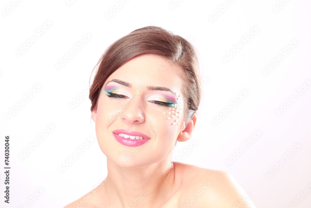 Beautiful woman posing in the studio wearing colorful make up Beautiful woman posing in the studio wearing colorful make up