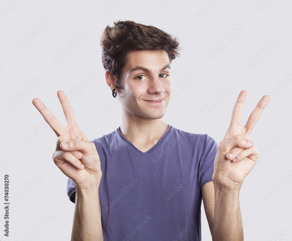 young man making victory sign young man making victory sign