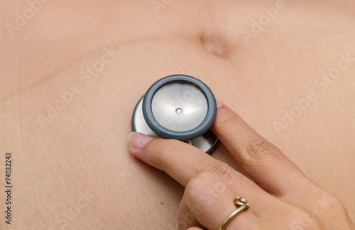 Fotografi medical auscultation the belly of pregnant woman