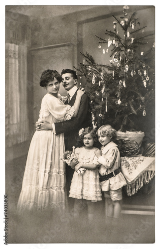 victorian family parents and children with christmas tree