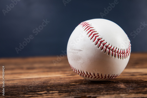 Baseball ball on wooden table photo