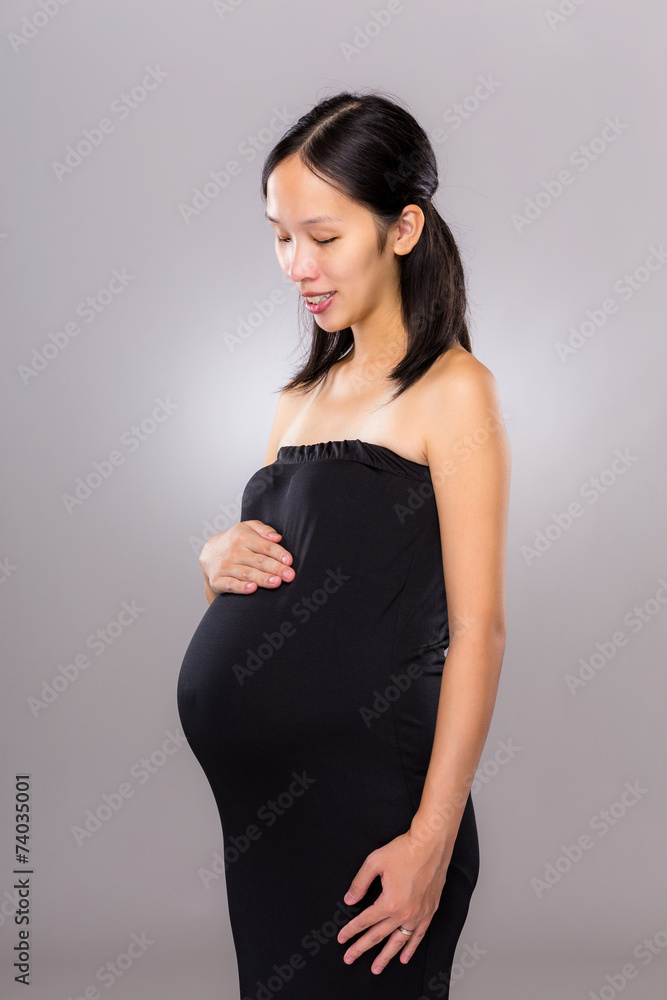Pregnant mother look at her belly Pregnant mother look at her belly