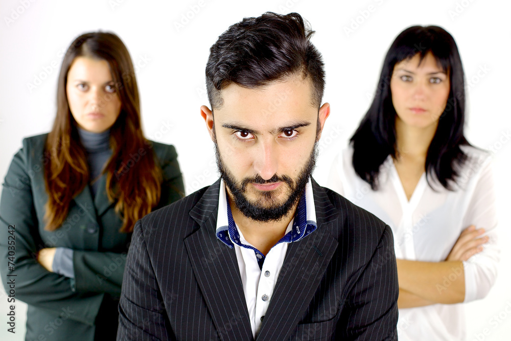 Serious business man with two women behind him Serious business man with two women behind him