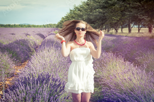 Beautiful girl on the background of lavender fields