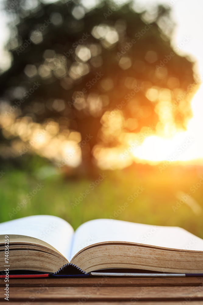Close up book on table in sunset time Close up book on table in sunset time