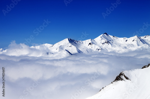 Winter snowy mountains under clouds at nice day © BSANI