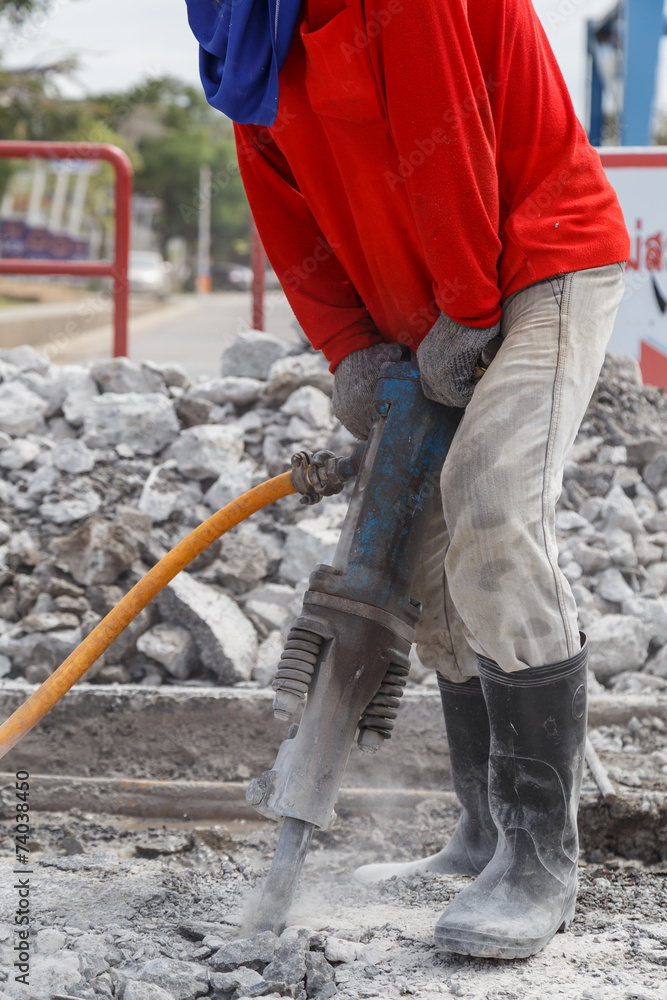 worker using construction drilling cement on the ground worker using construction drilling cement on the ground