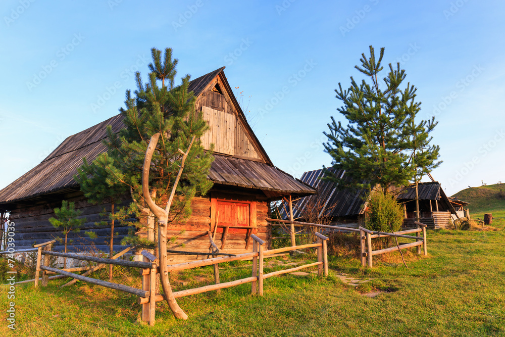 Shepherd wooden hut on meadow in autumn season Shepherd wooden hut on meadow in autumn season