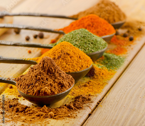 Selection of dried spices in spoons.