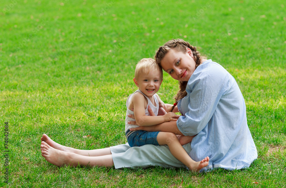 Pregnant woman and her son smiling Pregnant woman and her son smiling