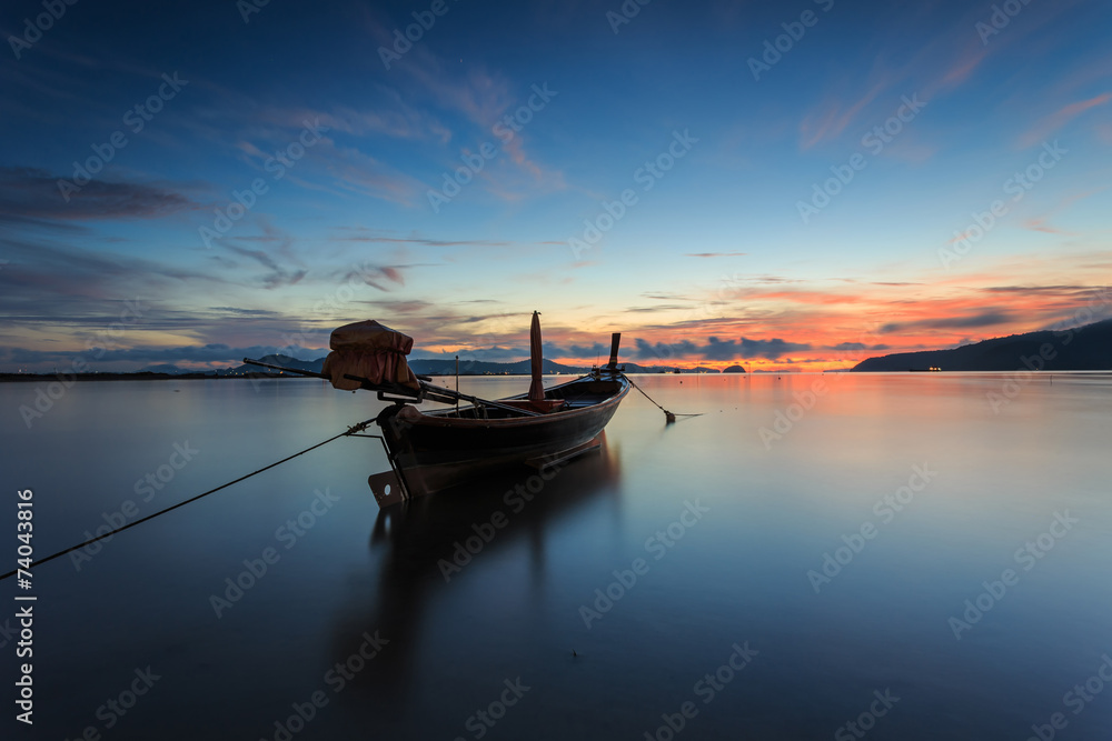 Silhouettes of longtail boat and sunrise in Phuket, Thailand Silhouettes of longtail boat and sunrise in Phuket, Thailand