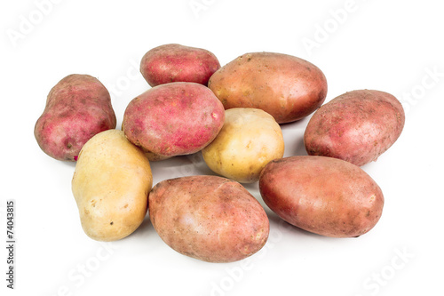 Red, pink and white Potato tubers on white background