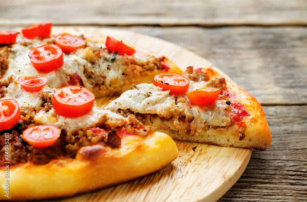 pizza with meat, mozzarella and tomatoes