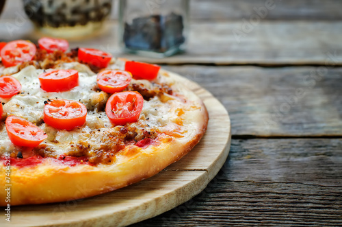 pizza with meat, mozzarella and tomatoes