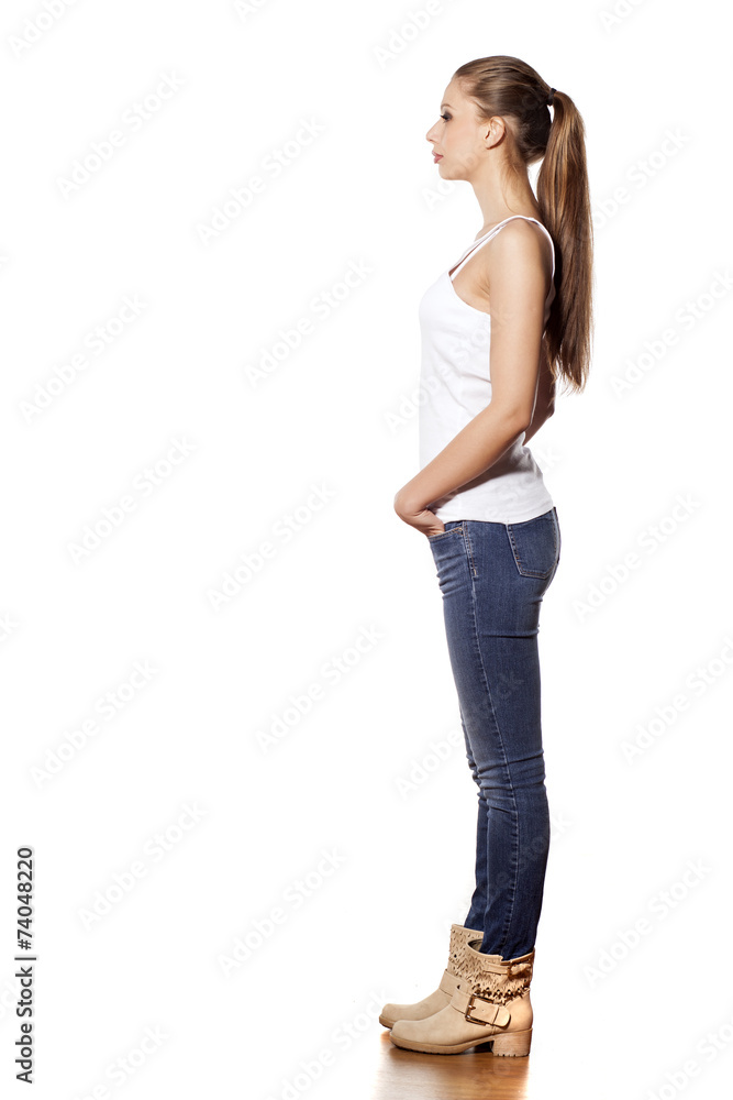 Side view of beautiful young woman in jeans and boots Stock Photo | Adobe  Stock