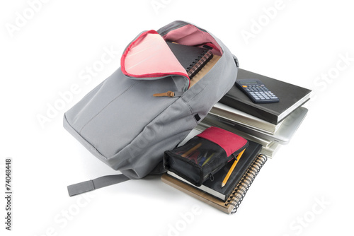 Backpack full of school supplies. on white background.