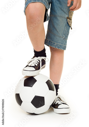 feet shod in sneakers and soccer ball
