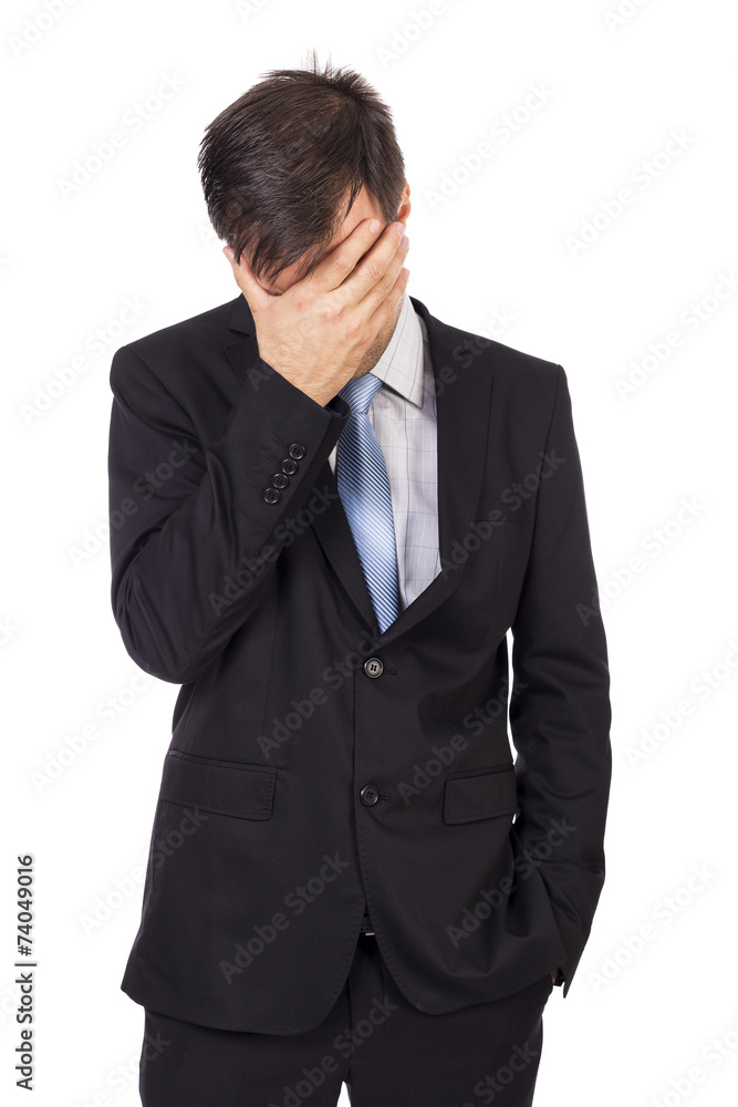Portrait of exhausted young businessman covering his face with h Portrait of exhausted young businessman covering his face with h
