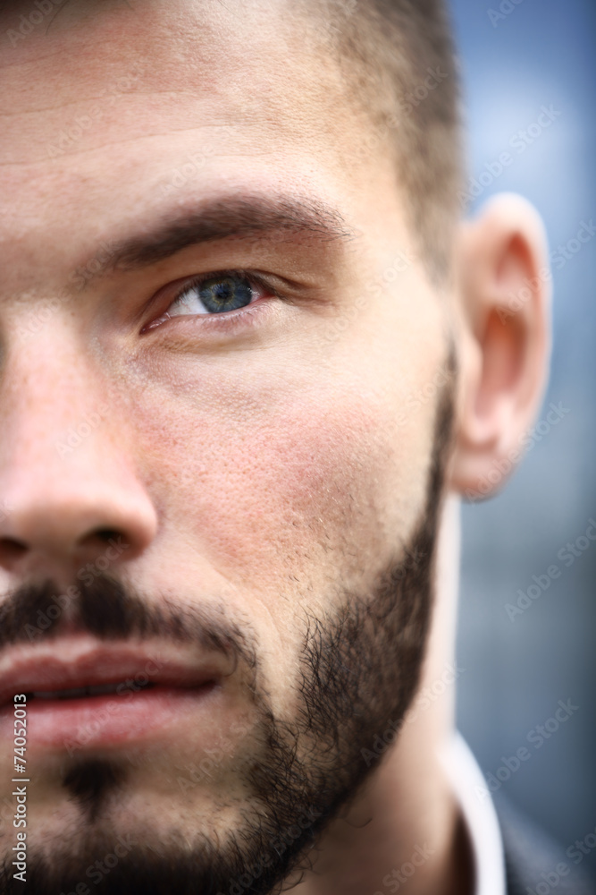 Obraz premium Charming and handsome man half face close up