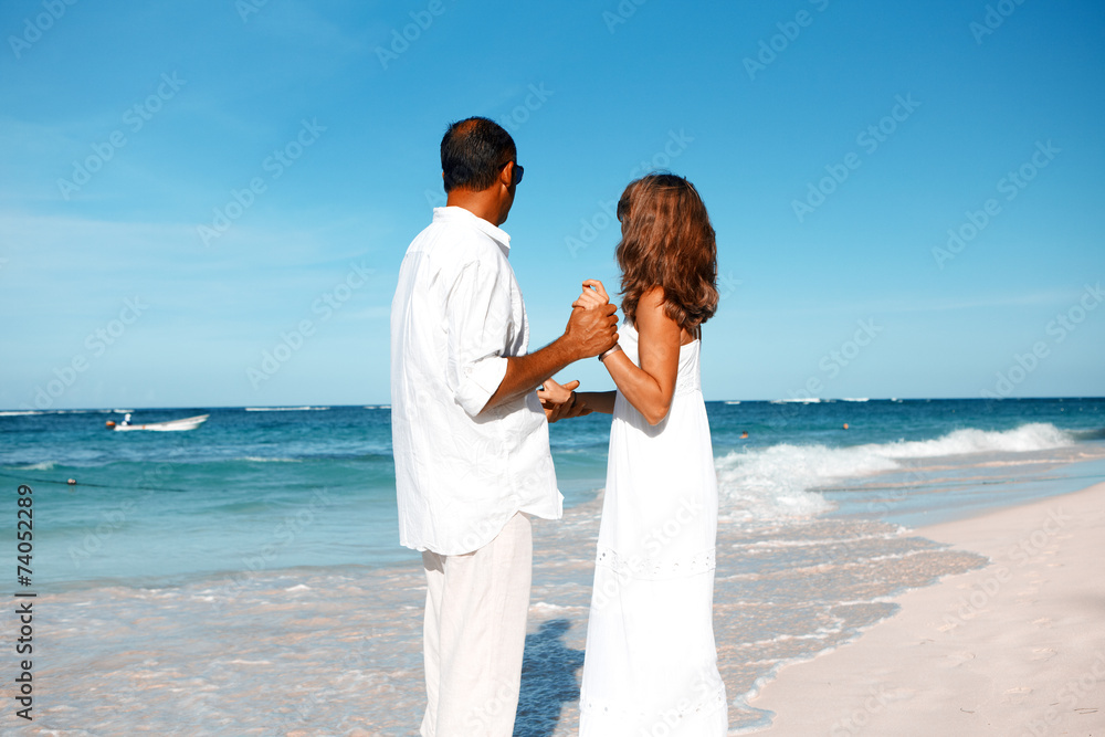 Loving couple looking the ocean Loving couple looking the ocean