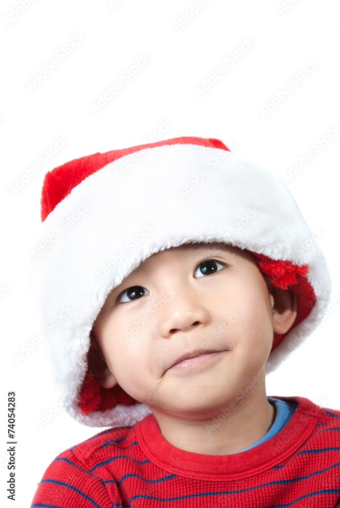 Cute Vietnamese boy wearing Christmas hat on white background Cute Vietnamese boy wearing Christmas hat on white background