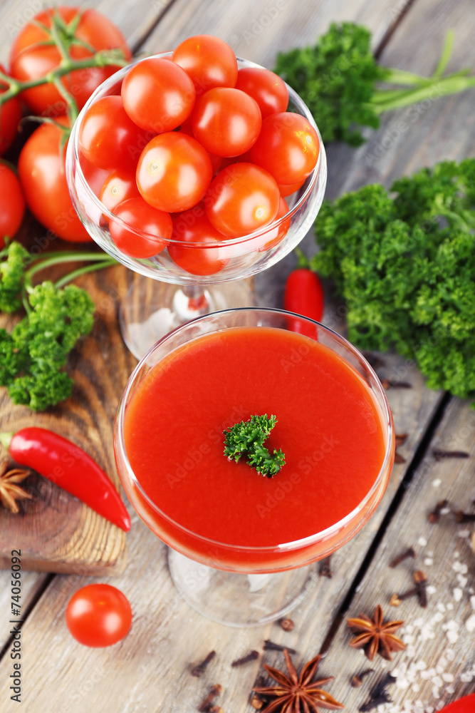 Tomato juice in goblet and fresh vegetables Tomato juice in goblet and fresh vegetables