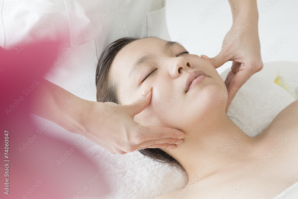 Asian women undergoing massage of face