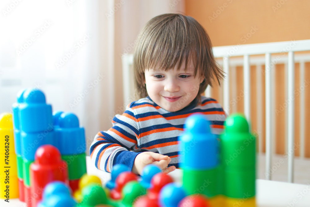 toddler boy plays plastic blocks toddler boy plays plastic blocks